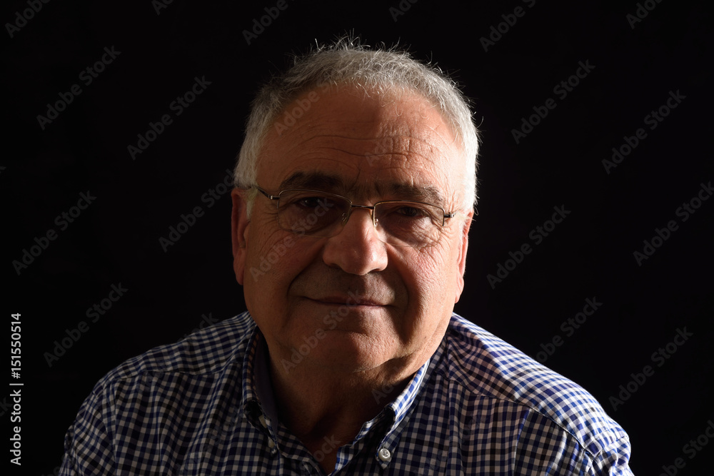 Obraz premium Portrait of a senior man with black background