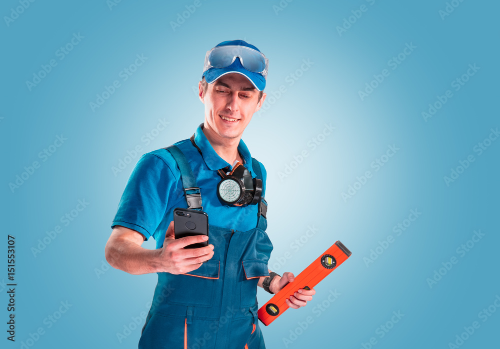 Handsome young handyman with a tool belt. House renovation service. Building concept. Handsome young handyman with a tool belt. House renovation service. Building concept.
