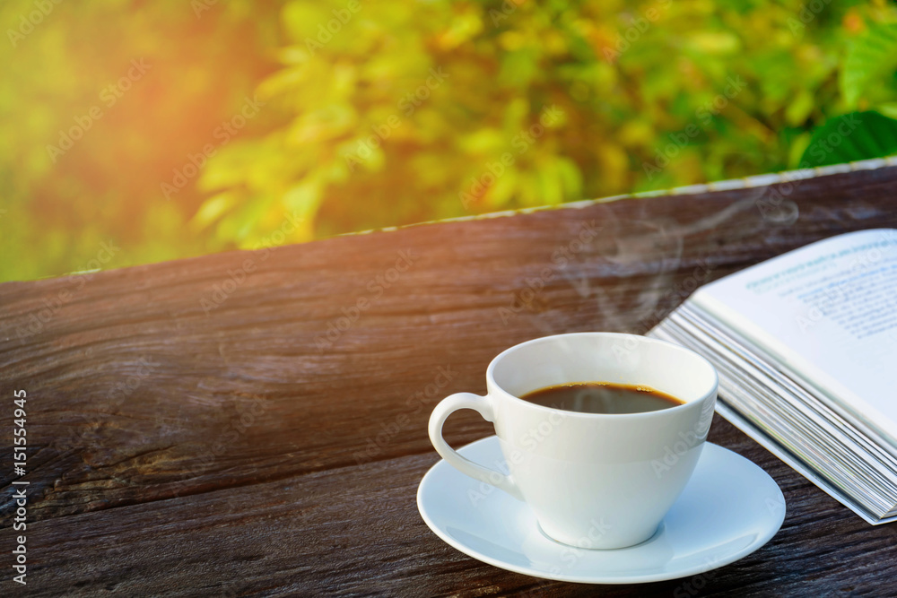 coffee cup clock and news paper on old wooden table coffee cup clock and news paper on old wooden table