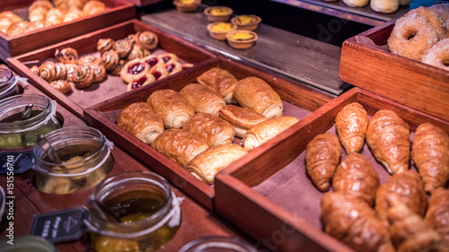 Croissant And Baked Bread On Wooden Tray