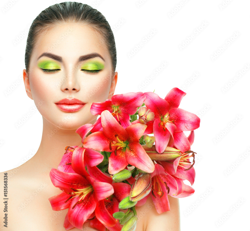 Beauty girl with lilly flowers bouquet. Beautiful spa model with blooming pink lily flowers