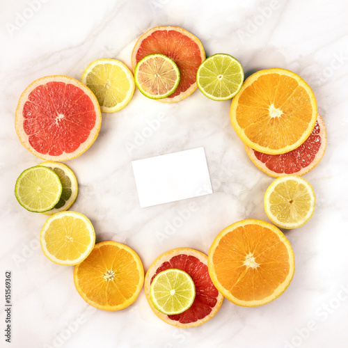 Vibrant citrus fruits with business card for copyspace