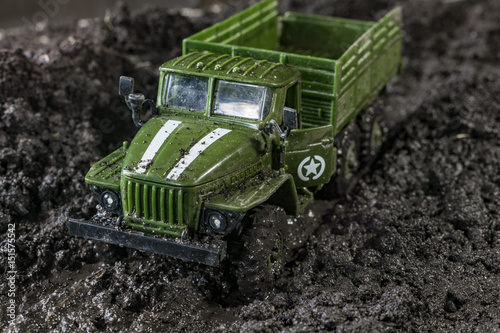 Toy military car in the mud