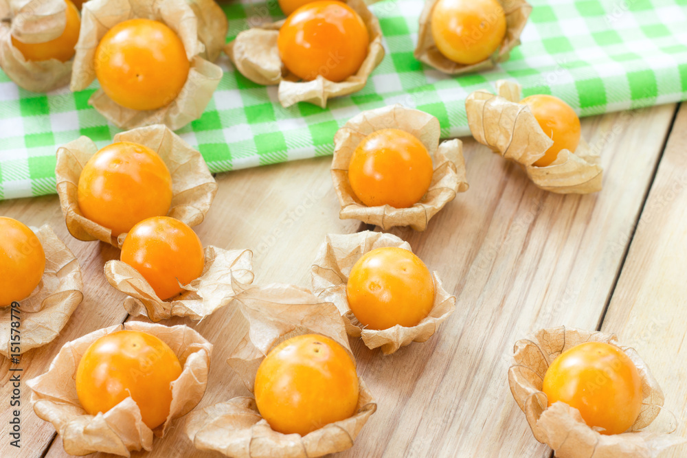Golden berries or physalis fruit on wooden table Golden berries or physalis fruit on wooden table