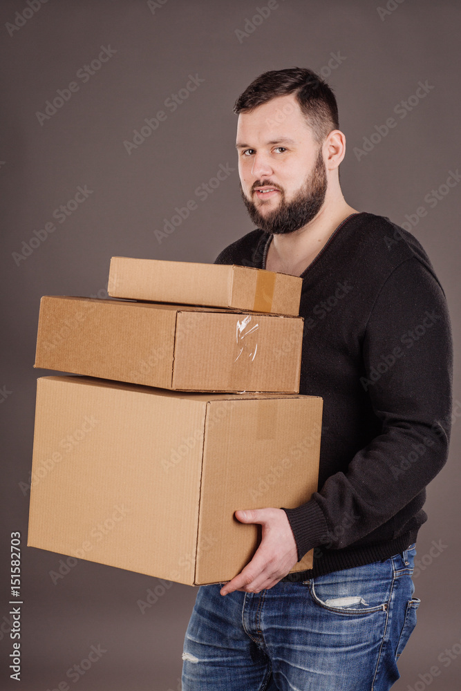 man holding pile of cardboard boxes in front man holding pile of cardboard boxes in front