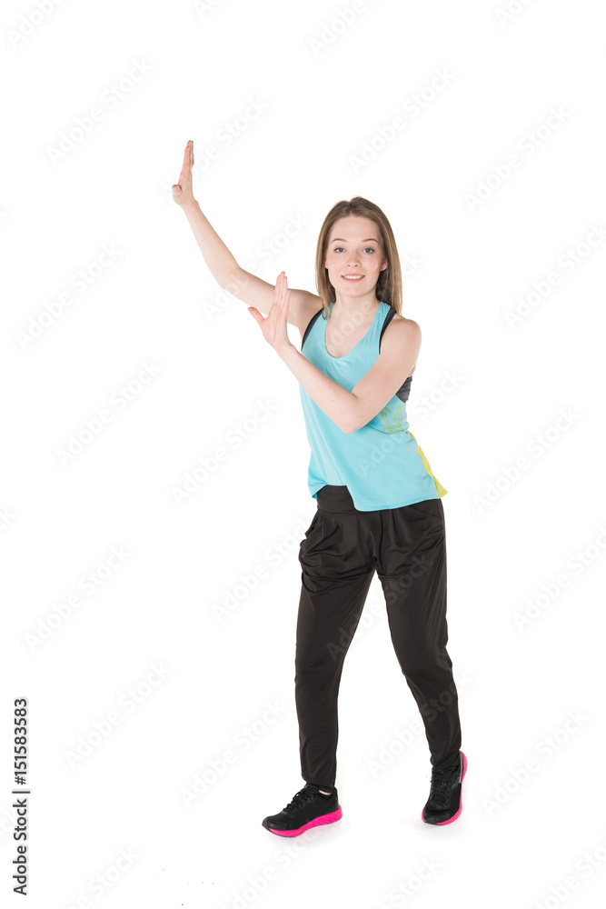 Young, pretty natural looking girl in sport t -shirt and jogging pants having fun dancing. Full body studio shot, pure white background. Young, pretty natural looking girl in sport t -shirt and jogging pants having fun dancing. Full body studio shot, pure white background.