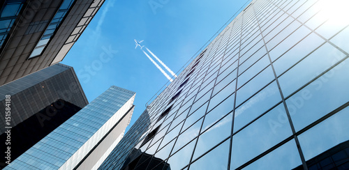 financial district of the city and airplane in the sky photo