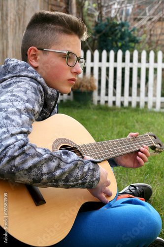 boy playing guitar photo