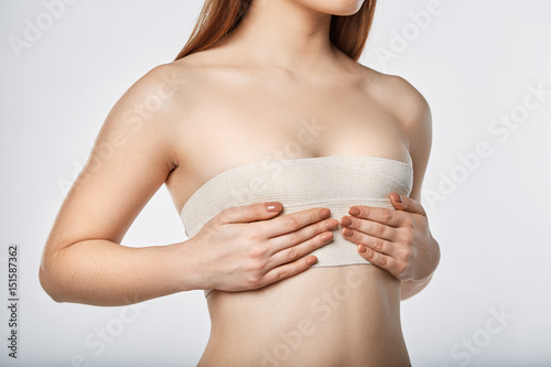 Fototapeta Woman breast with bandage surgery