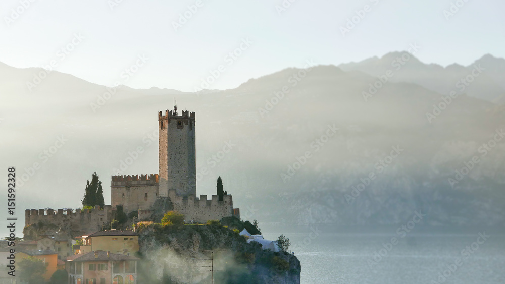 Medieval castle on the cliff against lake, Garda lake, Italy
