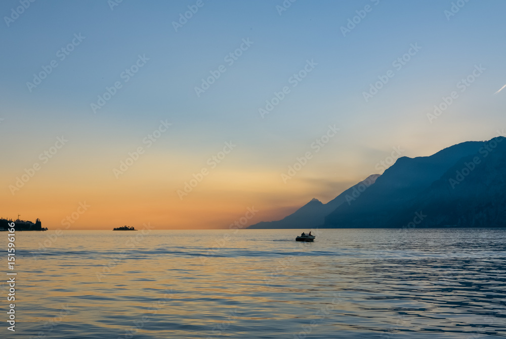 Fototapeta premium Evening landscape with couple on the boat