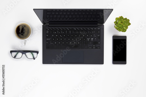 Contemporary white office desk with Laptop and Coffee Cup photo