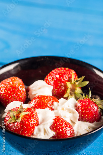 Closeup macro fresh strawberries in whipped cream