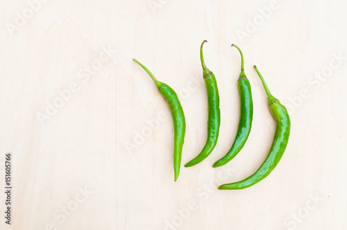 fresh green hot chilli peppers with spicy on the wooden