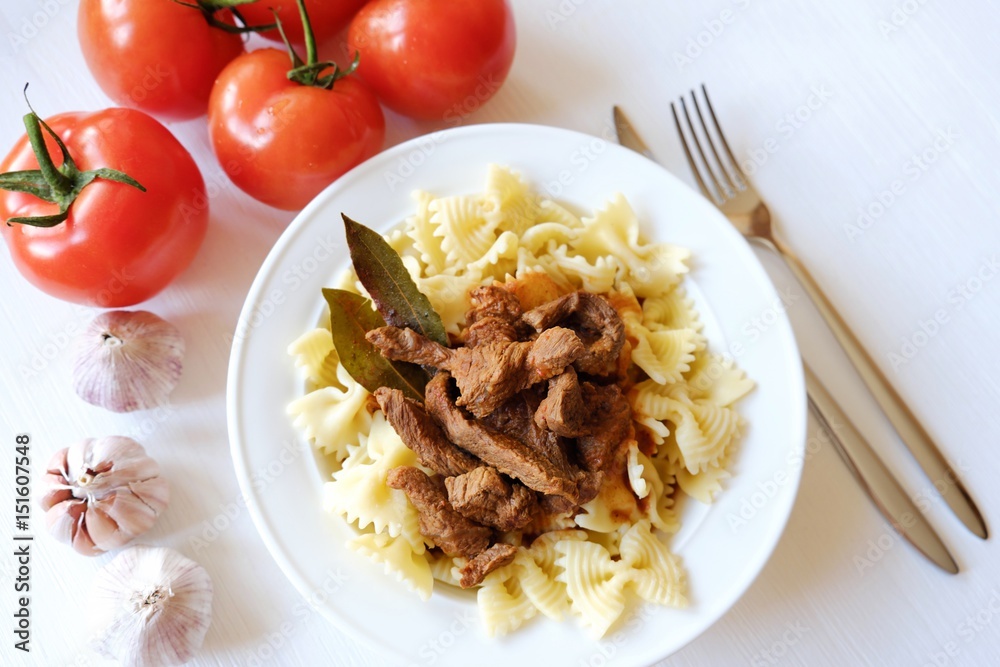 Pasta with beef in tomato sauce and laurel leaf spices 