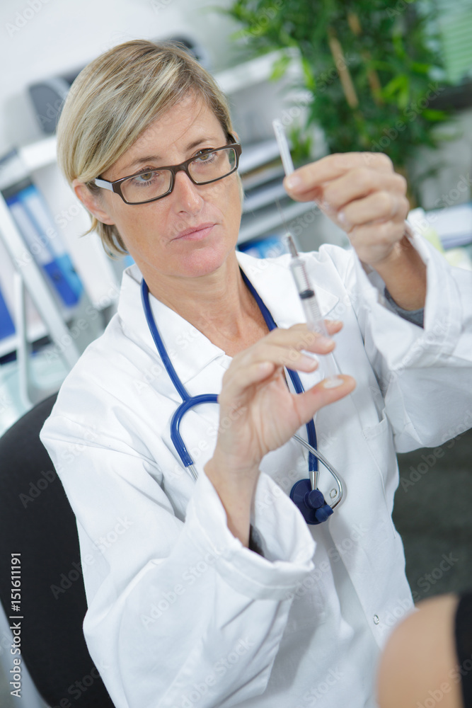 Doctor preparaing syringe Doctor preparaing syringe