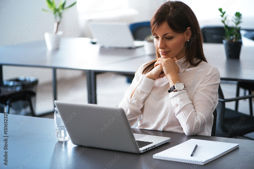 Portrait of young attractive woman at office desk, with laptop. Portrait of young attractive woman at office desk, with laptop.