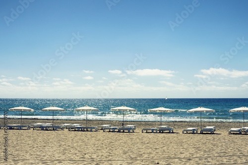 umbrellas and chairs in alicante beach.Spain © kemirada