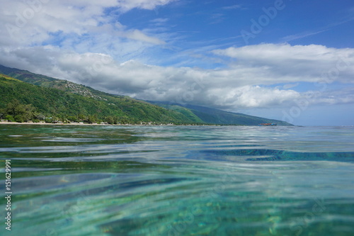Tahiti island coastal landscape seen from sea surface in the lagoon, West coast near Punaauia, French Polynesia, south Pacific ocean