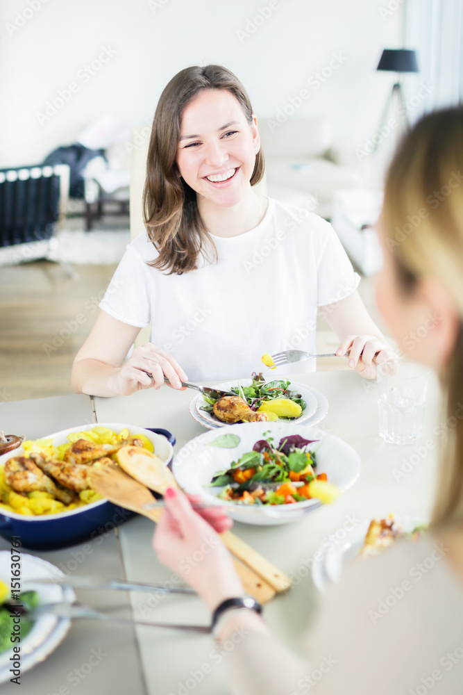 Two happy women having dinner together