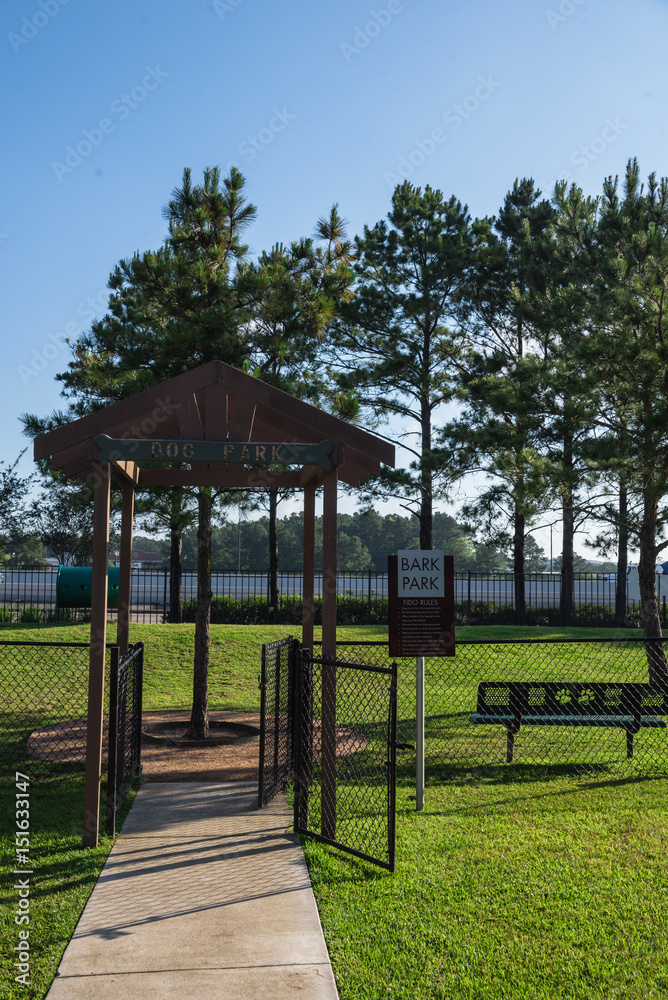 Community on-site dog park at the grassy backyard of a typical apartment complex building in suburban area at Humble, Texas, US. Off-leash dog park with pet stations, toys and bag dispensers Community on-site dog park at the grassy backyard of a typical apartment complex building in suburban area at Humble, Texas, US. Off-leash dog park with pet stations, toys and bag dispensers