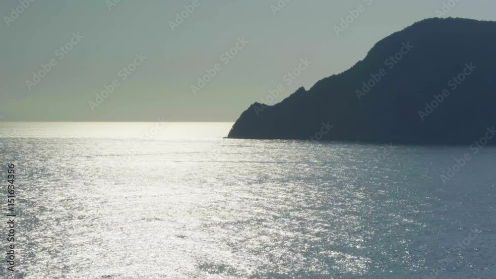 view of ocean mediterranean sea on rocky shore beach coast, near travel landmark destination Cinque terre National Park, Liguria,Italy. Sunset weather reflections. 4k top view drone side video shot view of ocean mediterranean sea on rocky shore beach coast, near travel landmark destination Cinque terre National Park, Liguria,Italy. Sunset weather reflections. 4k top view drone side video shot