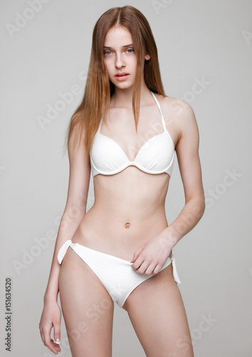 Young fit fashion model wearing white bikini © DenisMArt