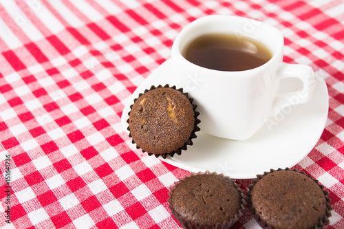 Mini muffins with cup of tea on tissue