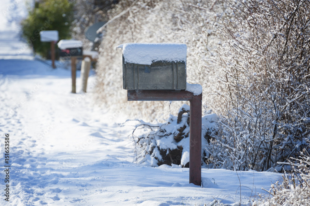 Snow Covered Mailbox. Winter snow caps a mailbox along a country road on Lummi Island in the San Juan Islands of Puget Sound. Snow Covered Mailbox. Winter snow caps a mailbox along a country road on Lummi Island in the San Juan Islands of Puget Sound.