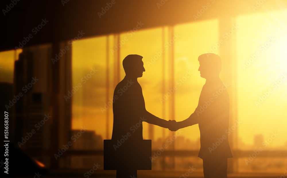 Second hand business hand in concept office silhouettes and successful business partner.
