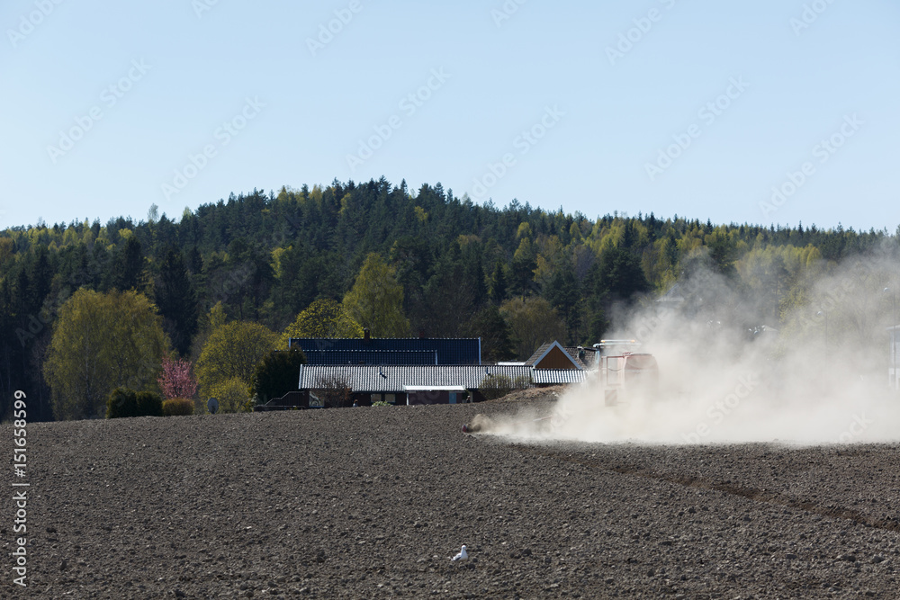Fototapeta premium Tractor working in farm field