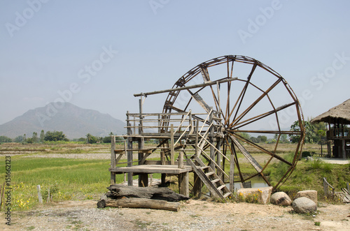 Big wooden turbine baler water wheel at Thai Dam Cultural Village in Chiang Khan at Loei, Thailand