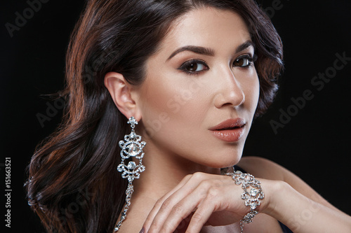 Portrait of young beautiful woman with luxury jewelry