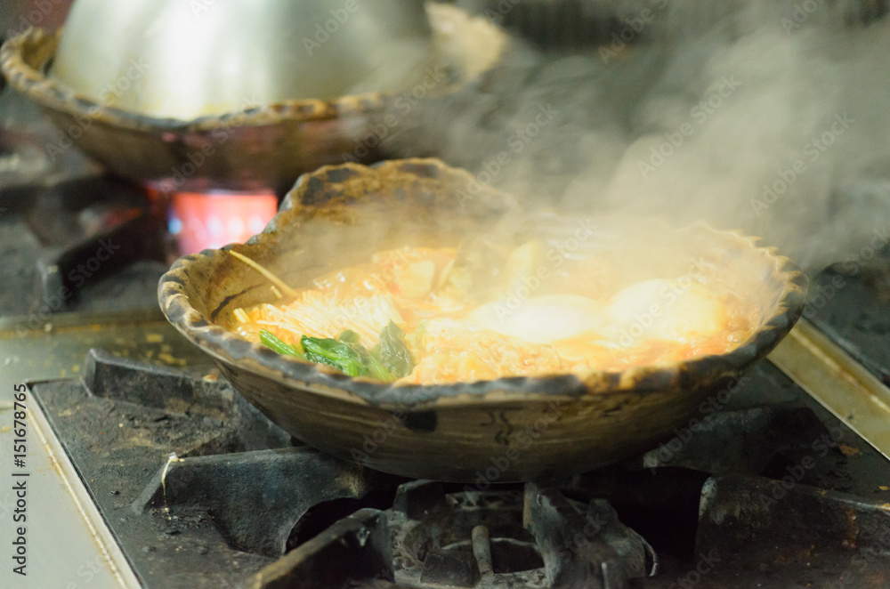 Food steaming in clay pot on gas stove Food steaming in clay pot on gas stove