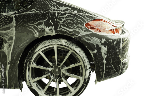 Car washing process of luxury black car full covered with white foam and bubbles