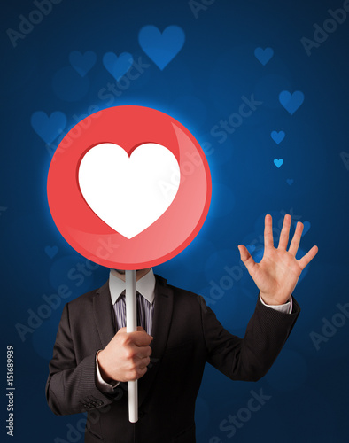Fototapeta Naklejka Na Ścianę i Meble -  Businessman holding heart sign
