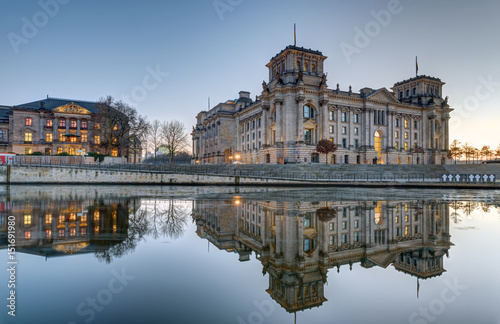 The Reichstag at the river Spree in Berlin at dusk