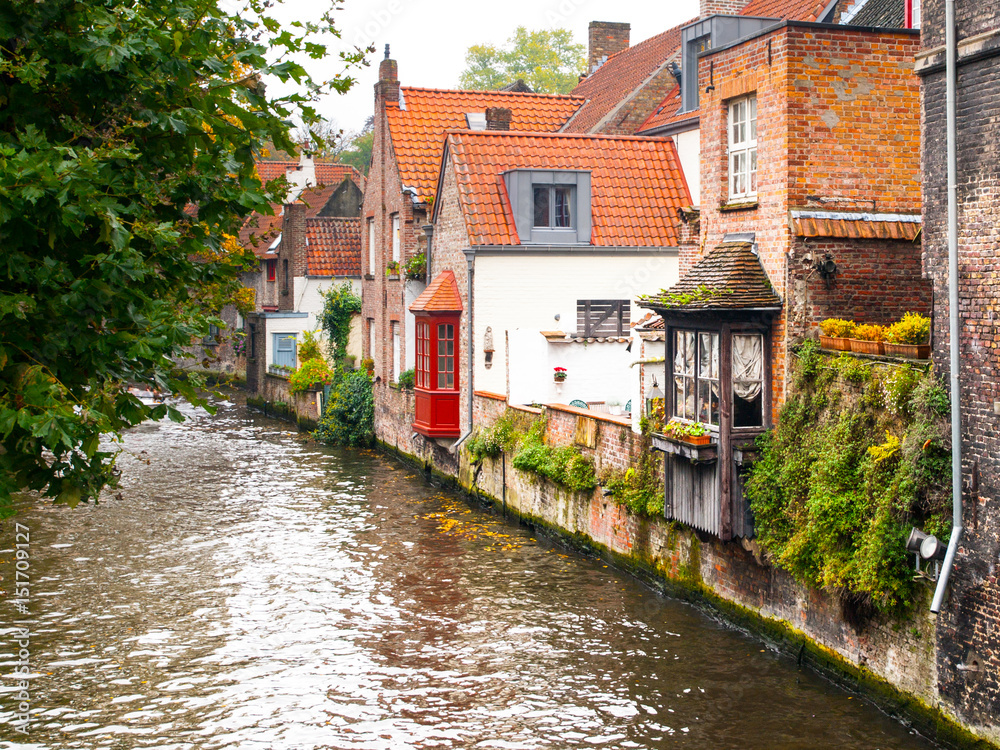 Old brick houses along water canals in Bruges, Belgium.