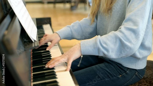 Girl playing the piano and looks worried while having a fail
