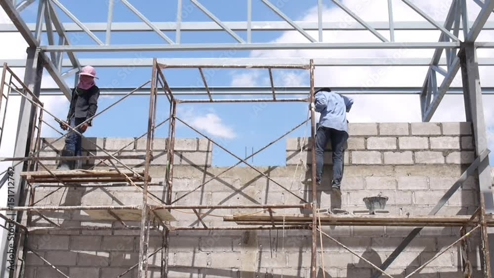Wall construction worker build concrete wall by cement block. Wall construction worker build concrete wall by cement block.