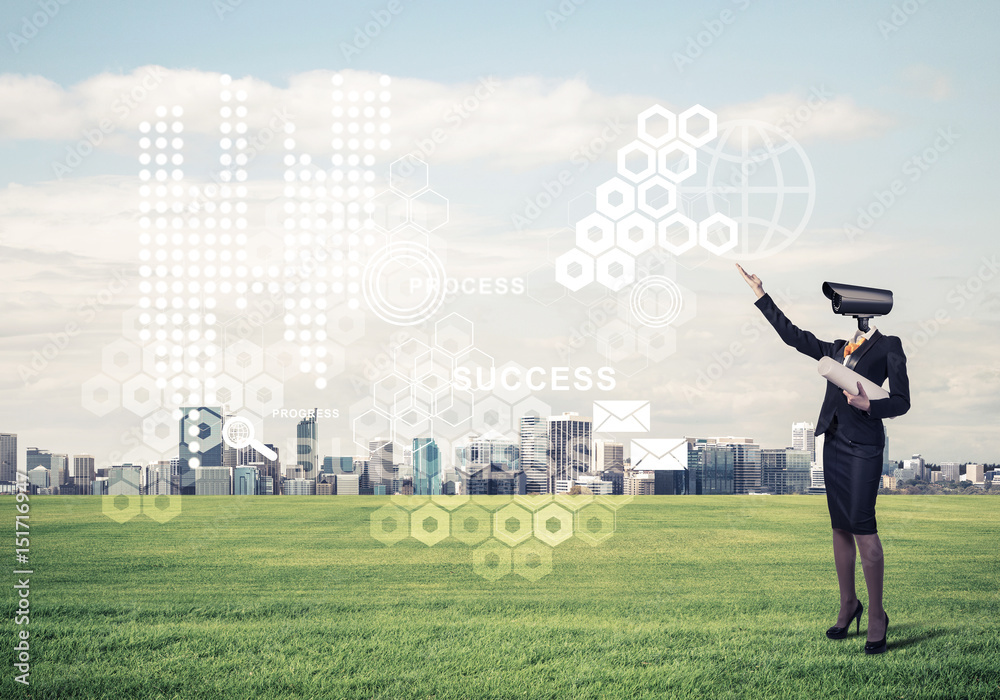 Camera headed woman standing on green grass against modern citys Camera headed woman standing on green grass against modern citys
