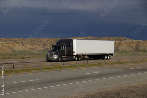 A silver or grey Western Star Semi-Tractor pulls a White unmarked trailer along Interstate 80 in Rural Wyoming on May 4th, 2017.