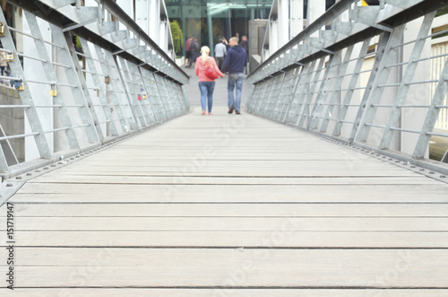Couple walking on the bridge, walk on the old wooden bridge. © parinya
