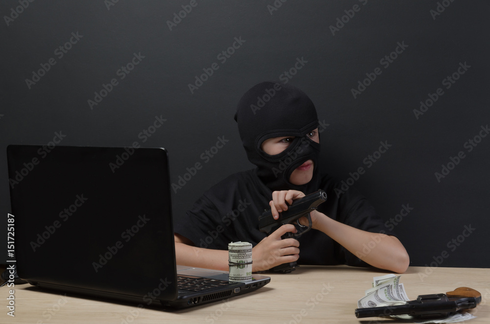 THE LITTLE BOY IN THE MASK OF THE TERRORIST BEHIND A LAPTOP THE LITTLE BOY IN THE MASK OF THE TERRORIST BEHIND A LAPTOP