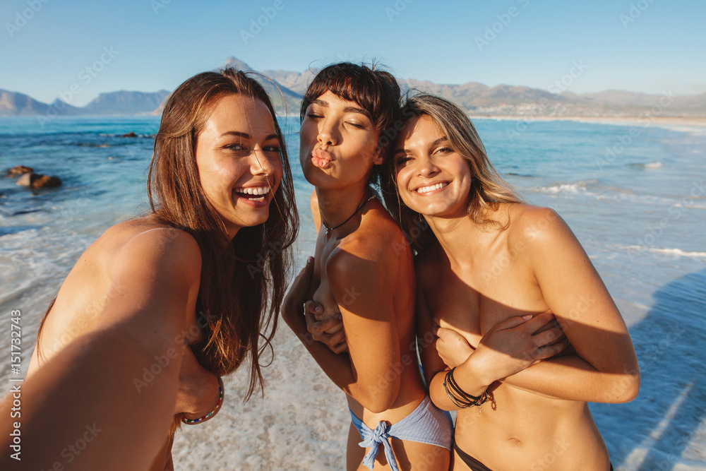 Group of female friends making selfie by the sea Group of female friends making selfie by the sea