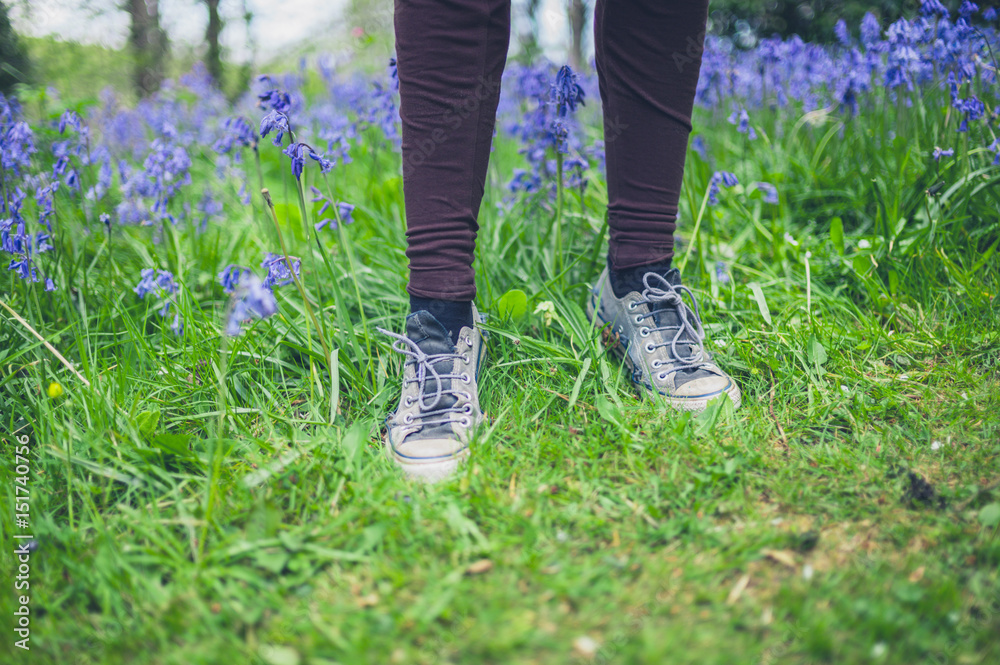 Feet of woman standing in meadow