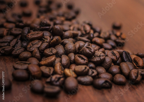 Black coffee beans on a brown tree