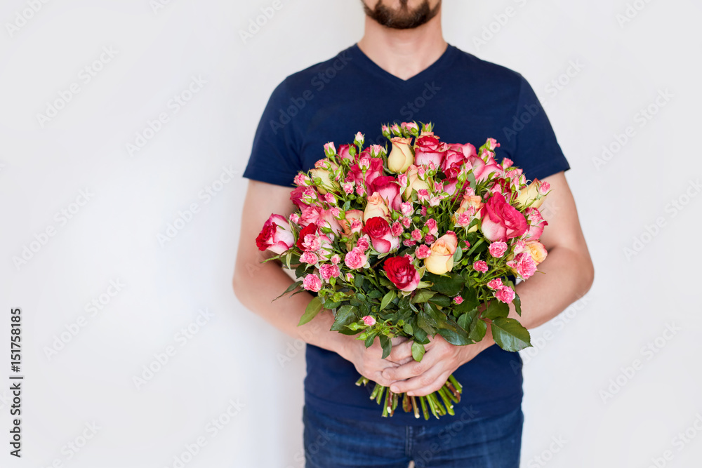 a man with red roses in the hands. valentine day love beautiful a man with red roses in the hands. valentine day love beautiful
