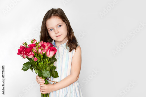 smiling little girl with a roses 