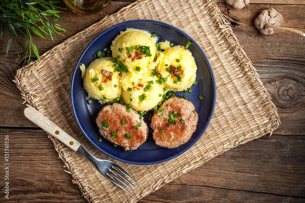 Meatballs served with boiled potatoes on a plate. Meatballs served with boiled potatoes on a plate.